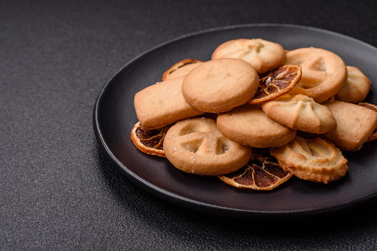 Delicious fresh sweet crispy butter grapefruit cookies on a dark background