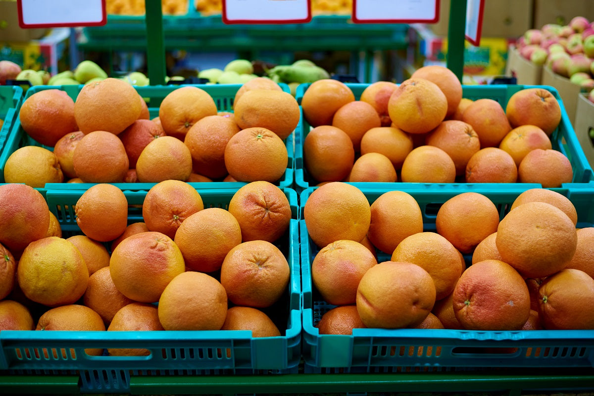 Crates of grapefruit for sale in a store.