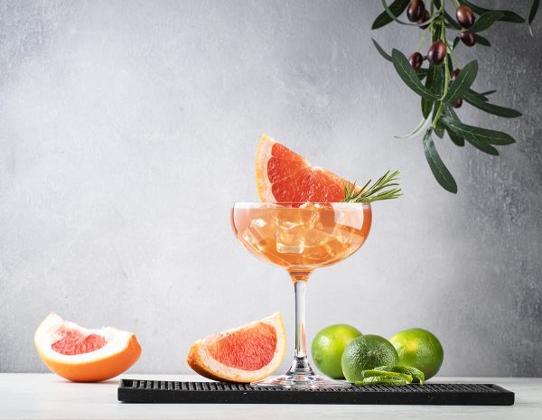 Grapefruit cocktail with grapefruit wedges, lime, and ice