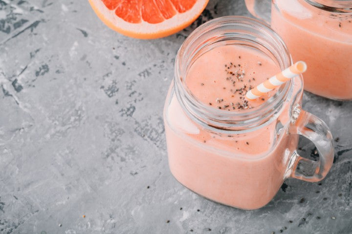 Red grapefruit and chia seed smoothie in a mason jar