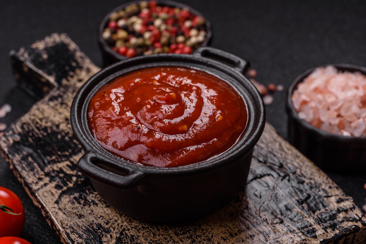 A reddish barbeque sauce in a bowl